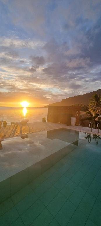 Infinity pool with sunset over the lagoon